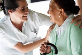caregiver and elderly woman smiling